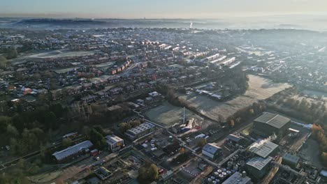 cold winters scene of aerial footage of a town city landscape, with low afternoon lighting and freezing sunlit houses