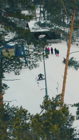 skiers and snowboarders have fun on wide slope covered with snow at popular big ski resort aerial view