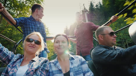 A-Cheerful-Family-With-Children-Is-Riding-In-The-Back-Of-A-Jeep-Safari-In-The-Forest-And-Mountains-A