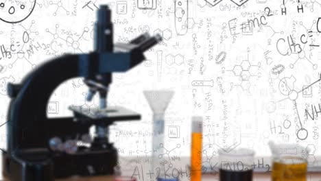 digital composition of chemicals equations and structures floating against microscope and test tubes