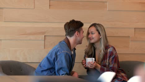 romantic couple kissing each other in cafe 4k