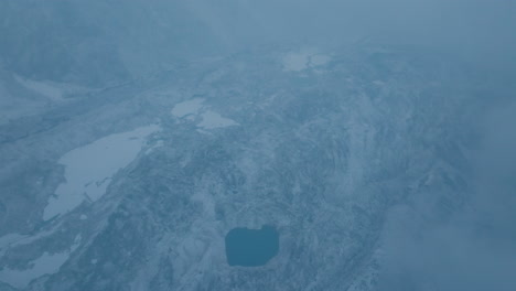 Aerial view of Khumbu Glacier near Everest Base Camp after snowfall. Scenic snowy mountains, melting ice into lakes, and unclear weather highlight global warming risks and nature conservation need