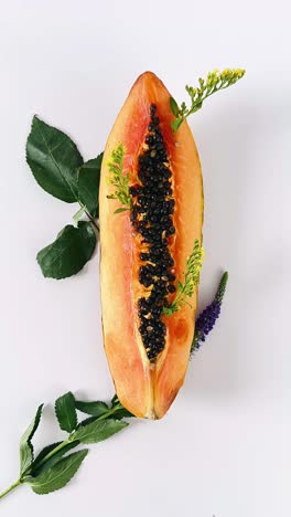 papaya slice with floral arrangement