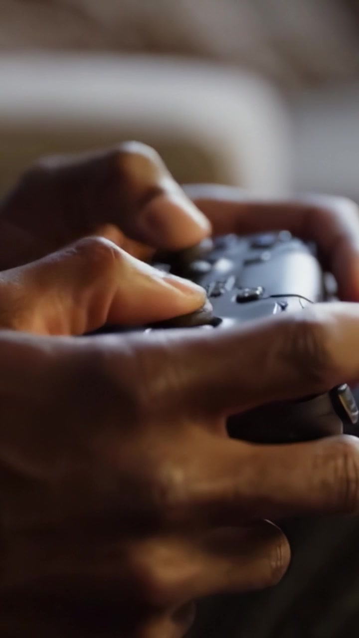 Engaging Moments of Gaming: An Intimate Close-Up of Hands Gripping a Game Controller, Highlighting the Excitement and Dedication of a Player's Experience