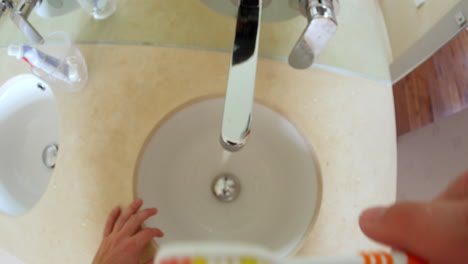 Point-of-view-of-man-brushing-teeth-in-a-bathroom