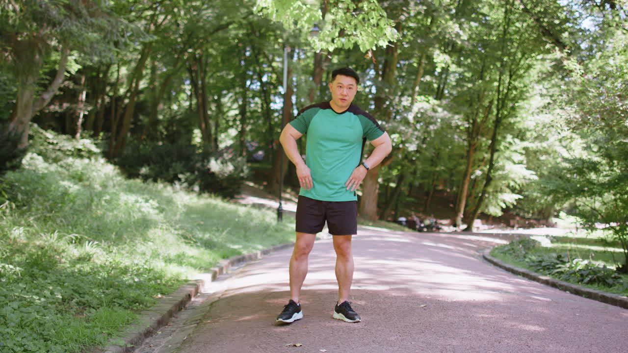 Asian young man sportsman male athletic trainer in good physical shape doing warmup morning sport