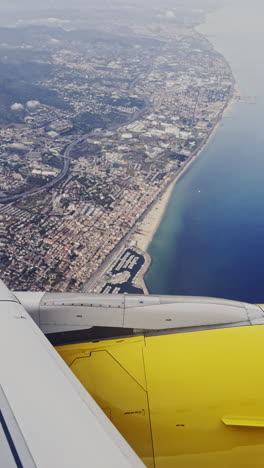 view from a plane window of the sky with the wing of the plane in shot in vertical