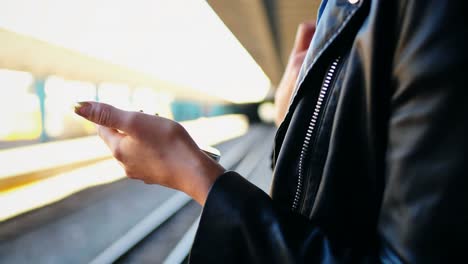 woman using mobile phone in railway station 4k