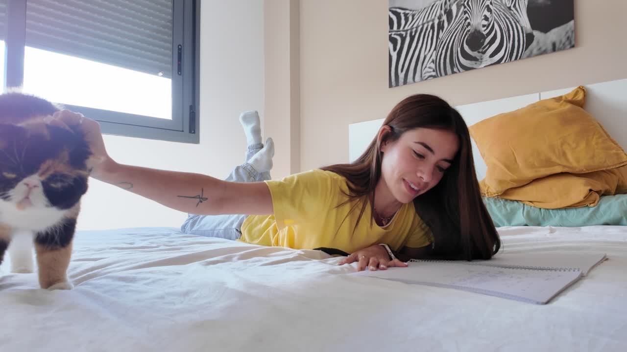 Woman with cat on bed