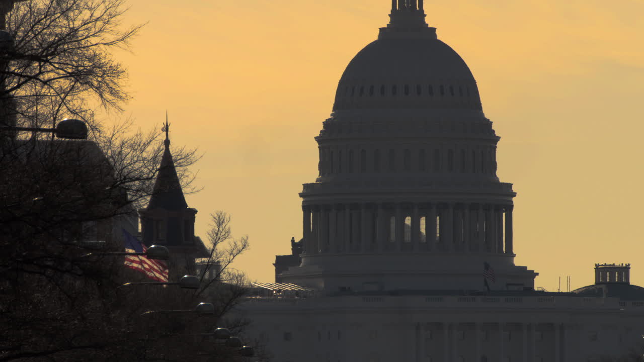 Dome of US Capitol Building in Washington DC at Sunset with Golden Colored Sky