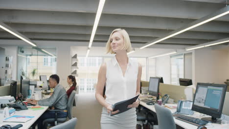 Business-power-woman-leader-walking-through-busy--corporate-office-planning-her-next-success-strategy