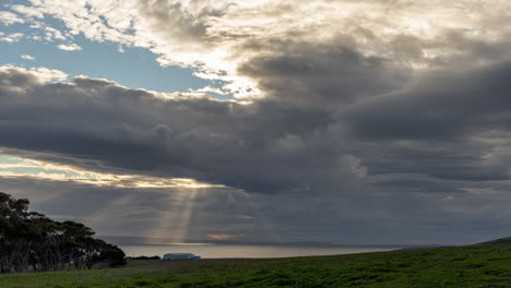 sunrays burst from a cloudy sky and illuminate the ocean in time lapse from kangaroo island