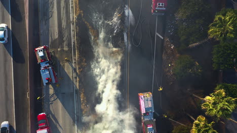 aerial top down shot above firefighters at a urban fire scene in california, usa