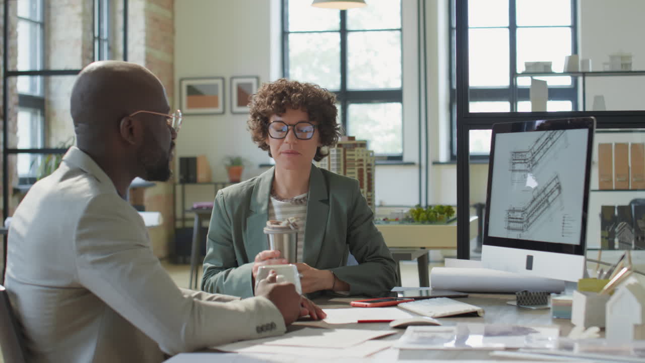 Architects collaborating on building plans in an office