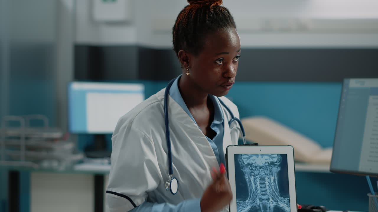 Doctor analyzing X-ray images on a tablet