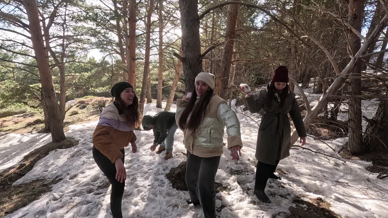 People having a snowball fight in the snow