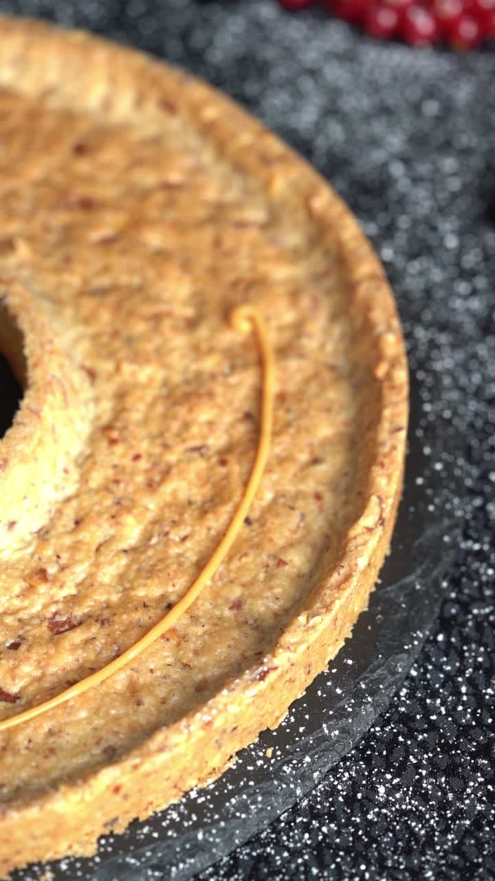 A skilled chef adding smooth caramel sauce to a delicious cake, close up shot, insert shot