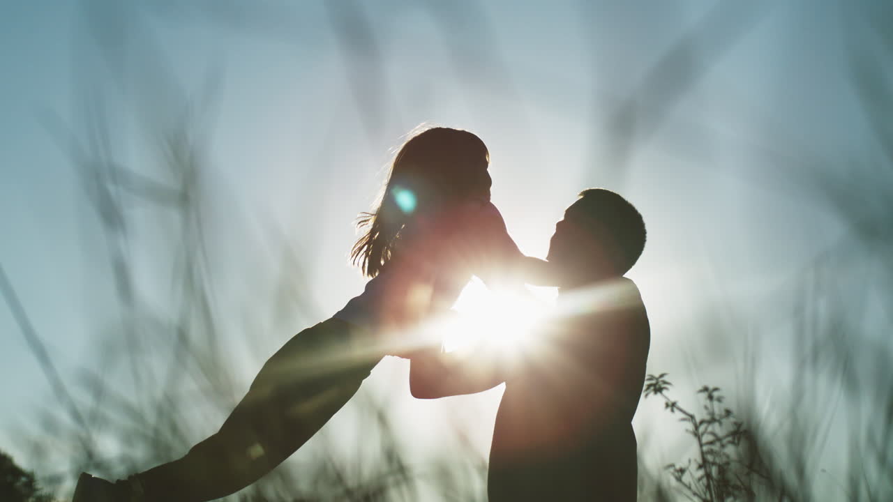 Father and Daughter Silhouette at Sunset