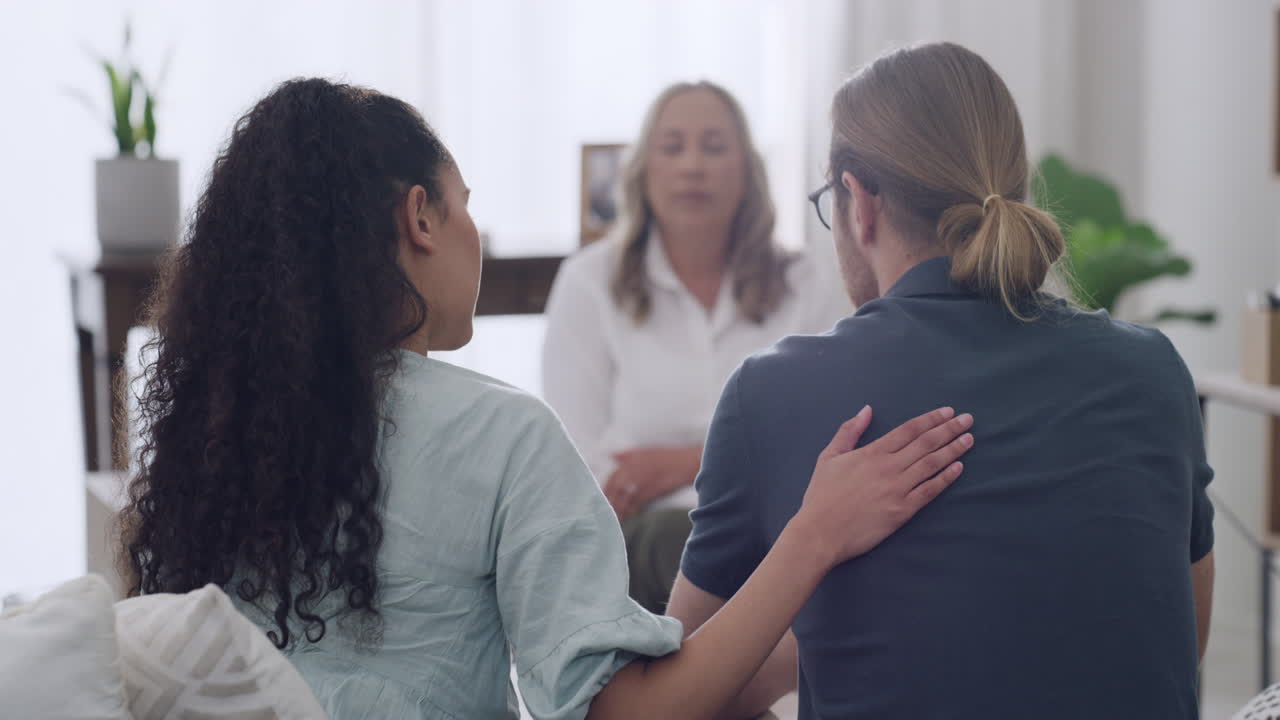 A young interracial couple comforting each other