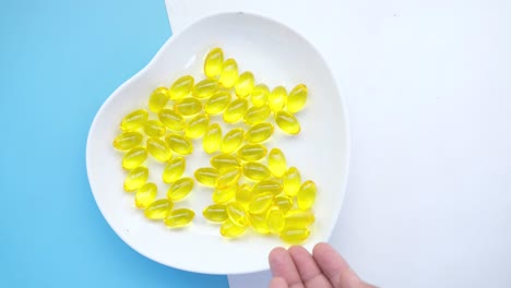 yellow gel capsules on a white plate