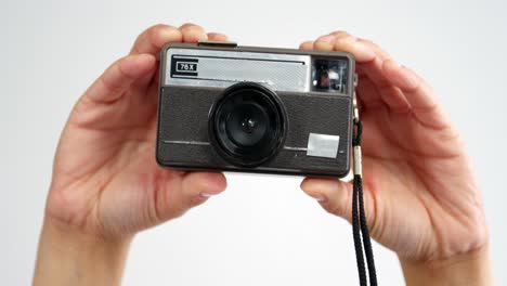 close-up of photographer taking photo with vintage camera