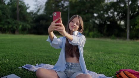 young woman taking a selfie in the park