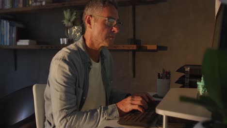 man using computer at home at night