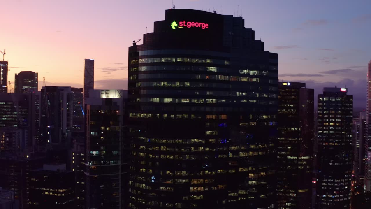 Aerial view of the St. George building illuminated at dusk in a city