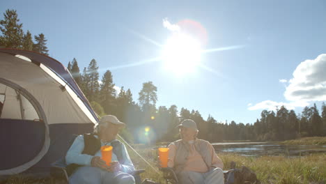 down-panning, closer-in shot of senior couple outside tent