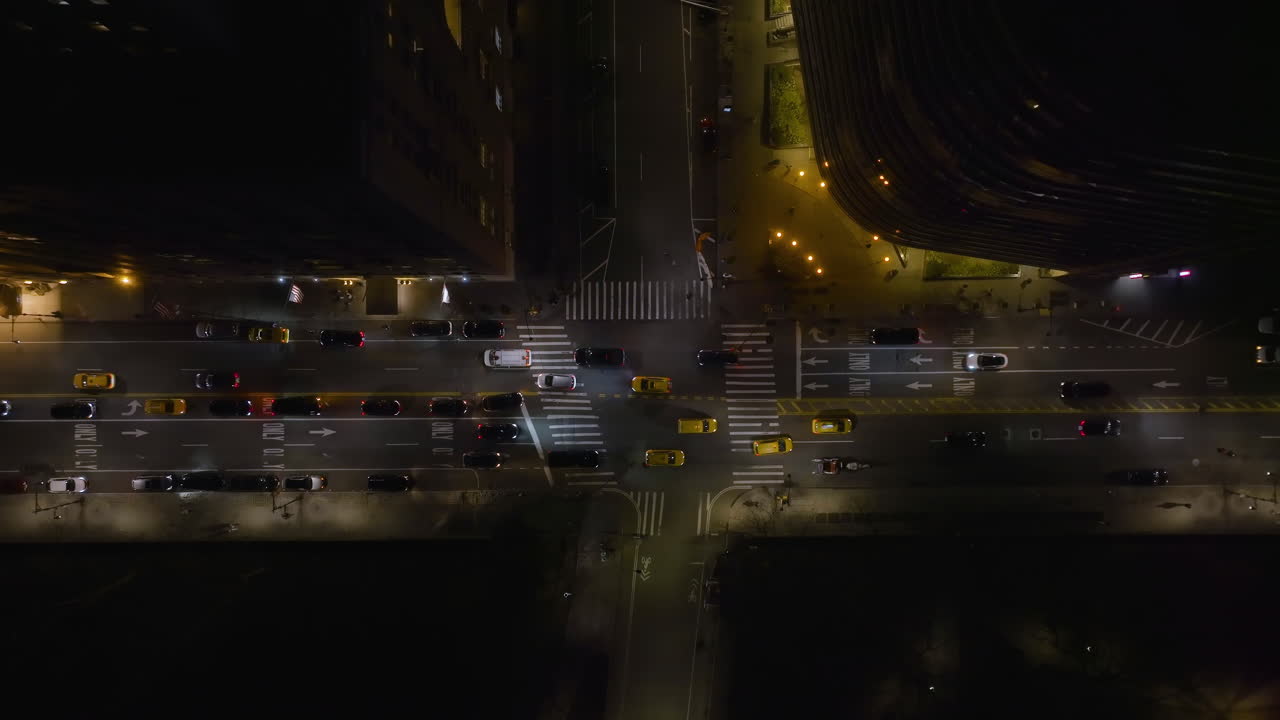 Aerial view above traffic on the West 59th Street, night in New York, USA - top down, drone shot