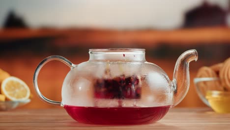 brewing hot tea in a glass teapot