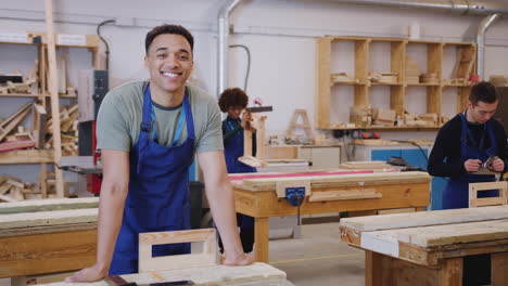 Portrait-Of-Male-Student-Studying-For-Carpentry-Apprenticeship-At-College