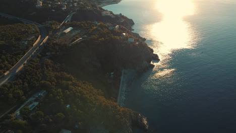 coastal landscape at sunset with highway and buildings