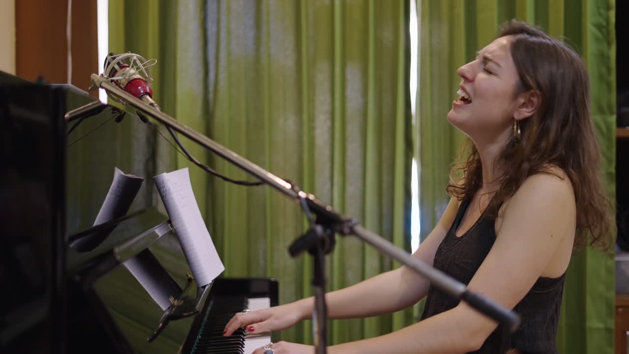 Female musician singing and playing piano