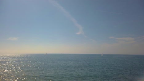 several sailboats sailing in the beautiful ocean on a sunny day