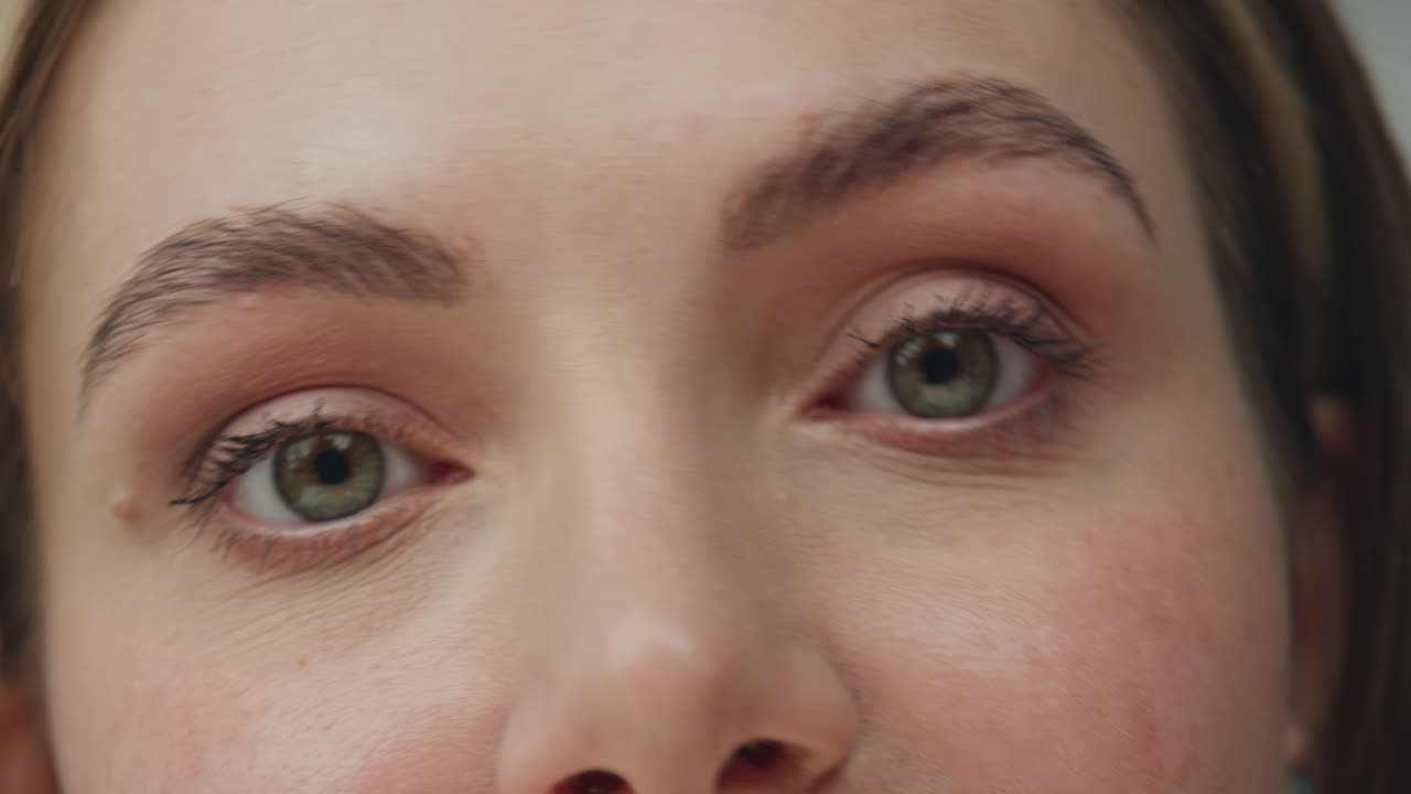 Close-up of a woman's face applying makeup