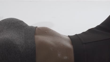 sweat droplets on the stomach of a fit woman doing stomach crunches