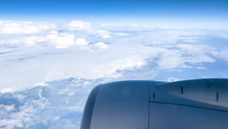 Airplane-wing-flying-over-a-vast-landscape,-a-perspective-of-the-world-from-above