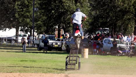 motorcyclist performing stunts before an audience