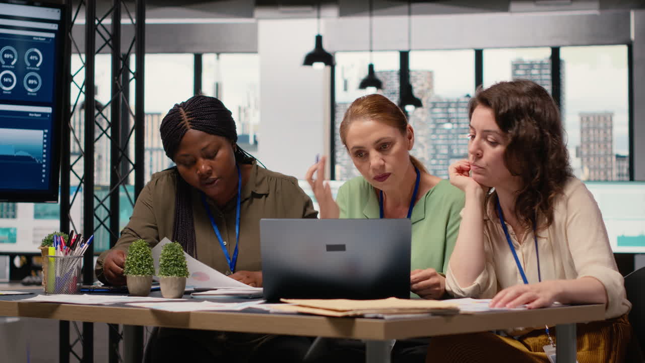 Vertical Video Confident powerful women gathering in the boardroom to evaluate data reports