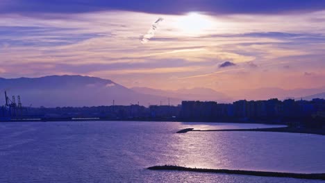 Purple-tinted-silhouette-of-the-bay-of-Malaga,-Spain
