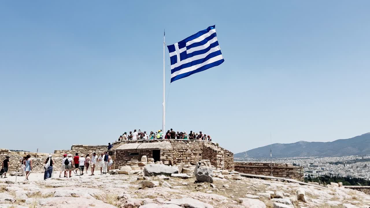 Tourists at the Greek Flag Viewpoint on the Acropolis, Athens, Greece