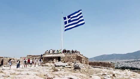 tourists at the greek flag viewpoint on the acropolis, athens, greece