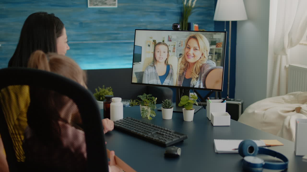 Mother and daughter using video call for conversation with friends