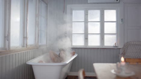 man with hat on lying in tub relaxing in calming steam bath, men's health