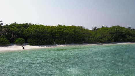 Drone-shoot-of-a-girl-on-a-private-beach-at-a-Maldivian-resort