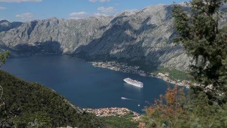 Kotor-Bay-mountains,-cruise-ship-and-town,-establishing-reveal-shot,-Montenegro