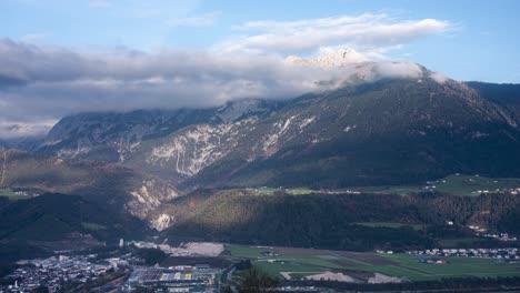 a breathtaking panoramic timelapse of the mountains in schwaz, austria. the camera moves from left to right, capturing the stunning alpine landscape and drifting clouds.