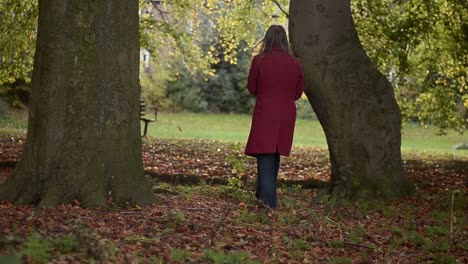 alone woman looks out through trees