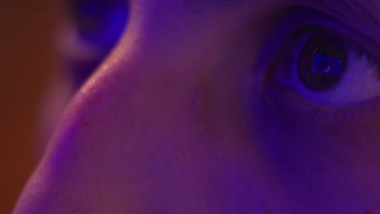 Reflection of a screen and streaming service in the eyes - isolated macro